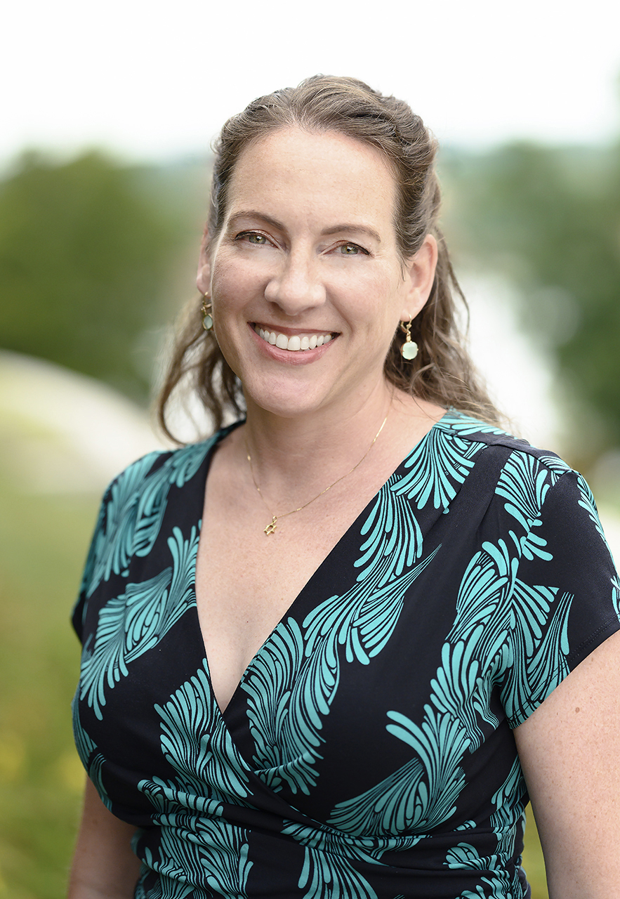Photo of Jolie Sheffer, smiling by Maumee river.