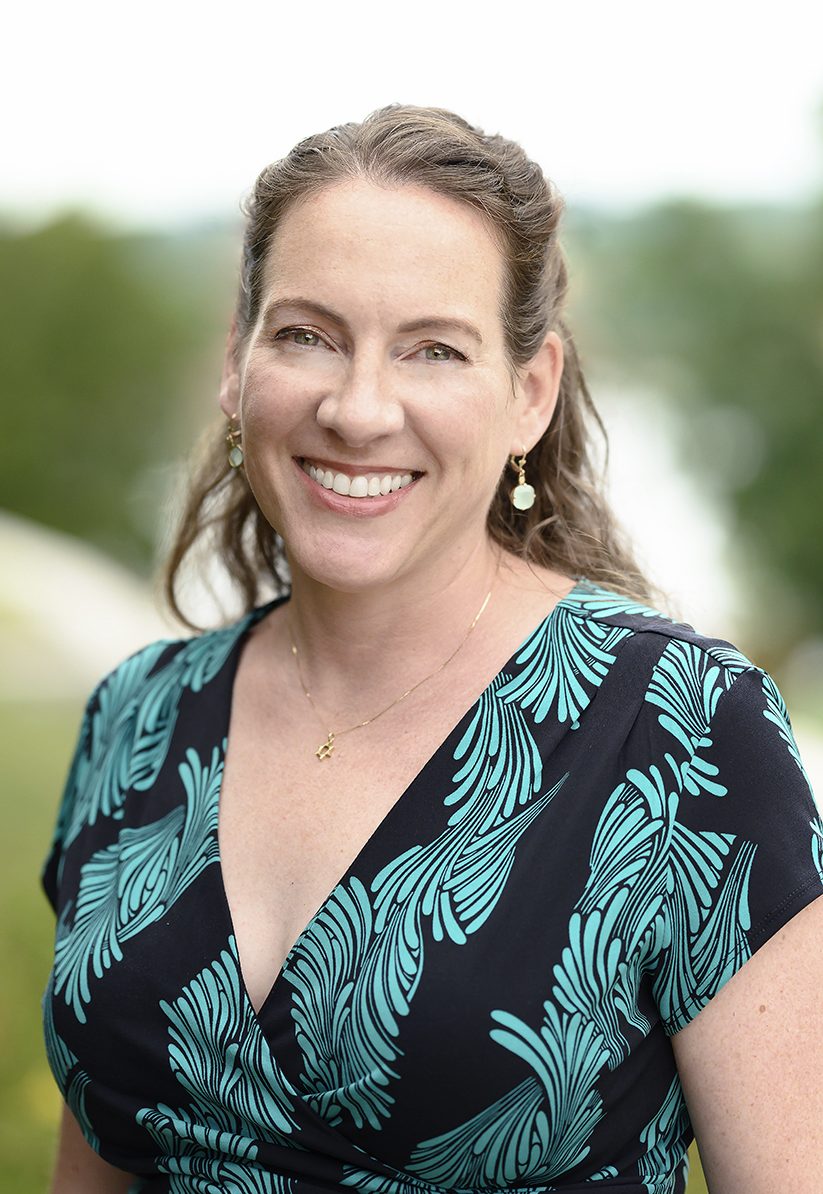 Photo of Jolie Sheffer, smiling by Maumee river.